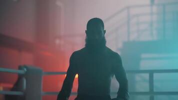 A man with a beard standing in a boxing ring video