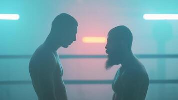 Two men standing in front of each other in a boxing ring video