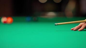 A person holding a cue stick on a green table video