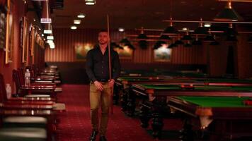 A man standing in front of a pool table video