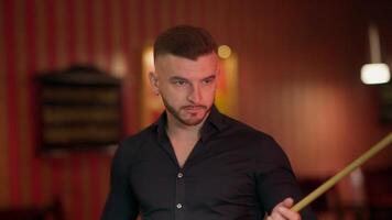 A man holding a cue stick in front of him video