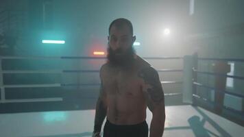 A man with a beard standing in a boxing ring video