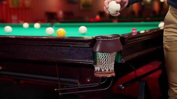 A man is holding a cue ball on a snooker table video