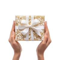 hands holding gift box with white and gold ribbon and bow side view isolate on transparent background png