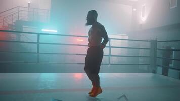 A man in a boxing ring with a red light video