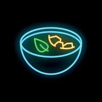 Neon sign of a bowl of soup with vegetables glowing on a black background vector