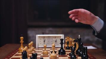 A man in a suit is playing chess on a table video