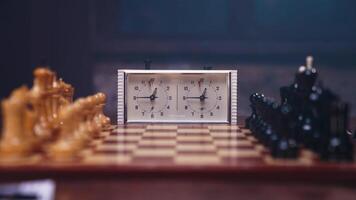 A clock and chess pieces on a table video