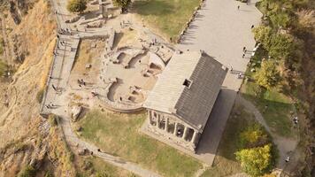 Aerial static view visitors by The Garni Temple - classical colonnaded structure in the village of Garni. Pagan temple.Symbol of pre-Christian Armenia.Ancient greek roman style landmark video