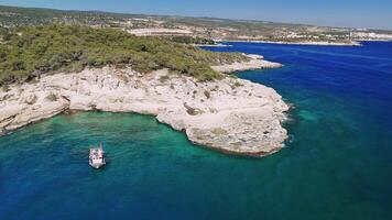 Boat approaches a stunning coastline featuring white cliffs rising majestically from turquoise waters. Lush green trees line the shore, creating a serene and picturesque landscape video