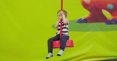 Child Playing on Swing in Indoor Playground video