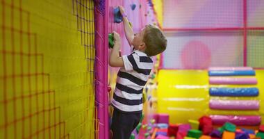 Child Climbing in Colorful Indoor Playground video