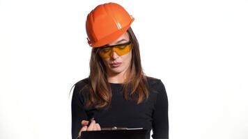 Female construction engineer. Woman builder isolated portrait with protect helmet video
