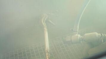 Hands of worker painting metal parts. Close up view of workman using spray gun for painting mechanical parts video