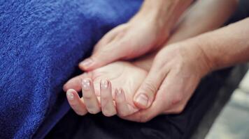 Hand massage in spa salon. Close up of kinesiologist applying pressure on hand of female patient video