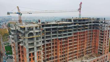 Construction site from height. Drone aerial view of new development with cityscape in background video