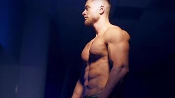 Man posing in gym. Handsome mature man standing strong in the gym and flexing muscles video