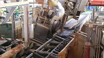 Automatic line sawing. Process of cutting logs into boards video