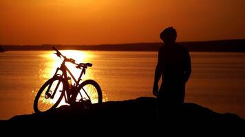 Rider resting on cycling trip in nature. Mountain biker looking at view on bike trail video