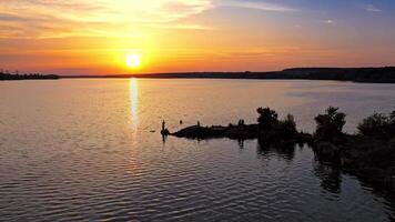 Atmospheric view of sunset. Reflection of sunset over river at evening video