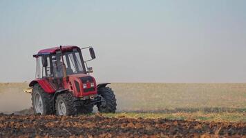 Tractor plows a field. Close up of tractor cultivating field video