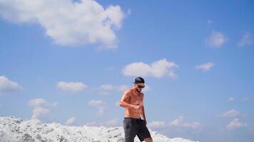 Man going down on mountain. Sportive man going down from steep descent of mountain video