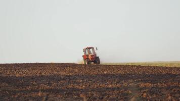 Farmer working in the field. Farmer in tractor preparing land with seedbed cultivator video