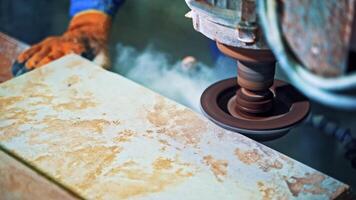 Worker processes granite stone. Grinder worker cuts stone block with electric saw video