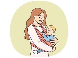 Mother holds baby in carrier sling and smiles, taking care of son and using comfortable babywearing. vector