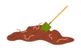 Soil with earthworms and a garden spade displayed in a backyard setting during daytime vector