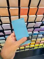 Customer Selecting Paint Swatches in Colourful Hardware Store Display. High quality photo