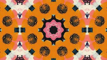 A symmetrical, abstract pattern featuring floral and geometric elements in vibrant colors. video