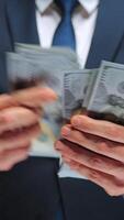 Formally dressed man is counting US Dollar bills, close-up. video