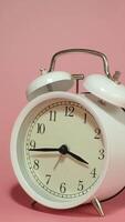 Vertical time lapse of a clock time passing over a day to night on pink background. video
