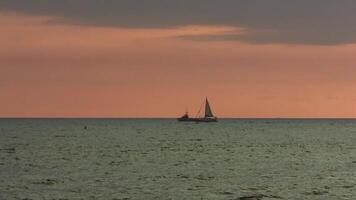 Sailboat Motoring Past Moored Boat At Sunset Off Hawaii Big Island Handheld video