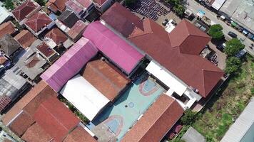 An aerial view of a school building with a large pool video