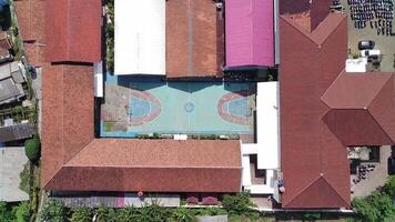 An aerial view of a school building with a pool video