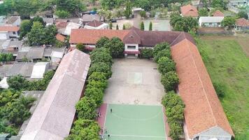 An aerial view of a school with a basketball court video