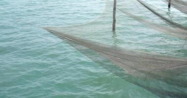 Lost fishing net with buoys lies underwater on the seabed. Problem of ghost gear. any fishing gear that has been abandoned, lost or otherwise discarded. It is the most harmful form of marine debris video