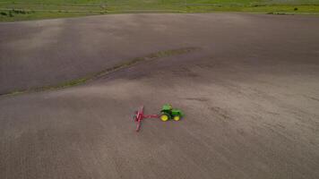 Spain, Seville - 07.02.2023. Combine harvester working in field view from drone video