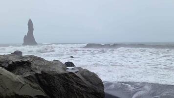 Powerful ocean waves crash against the shores of Iceland's renowned Endless Black Beach, creating a dramatic and unforgettable scene. video