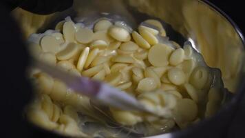White chocolate is heated and mixed in the pot video