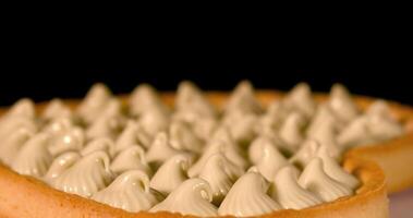 A cake with cream on top on a black background video