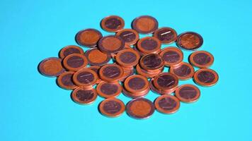 Euro coins rotate quickly on a blue background video