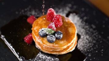 Syrup poured in slow motion on the pancake video
