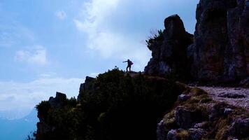 Girl raises her hands on a mountain with beautiful view video