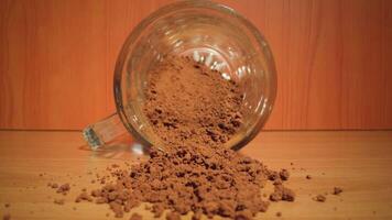 Instant coffee scattered on the table in front of the glass jar video