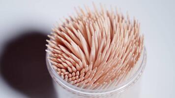Container with wooden toothpick on the table video