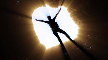 Silhouette of a boy illuminated by the rays of light video