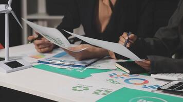 Eco business company meeting with group of business people using laptop to plan strategy and discuss marketing of eco-friendly and clean energy products. Green business company concept. Trailblazing video